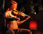 Two incredibly talented performers: juggler and balancing babe Miss Ellaneous with blindfolded violinist and poledancing beauty Danny De Mure. Photograph by Raymond Massa.
